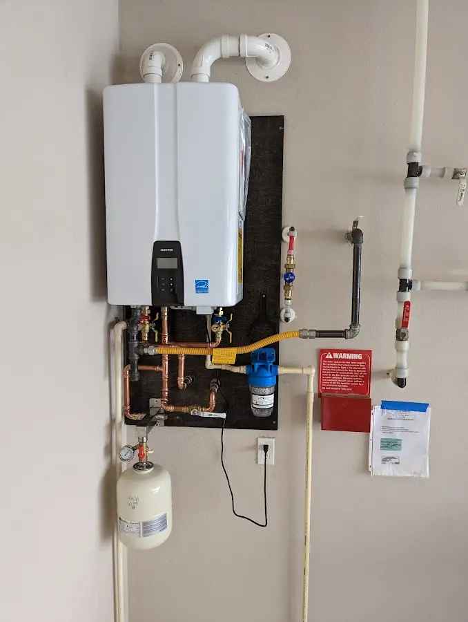 Professional plumber installing copper piping in a Hickory Creek home